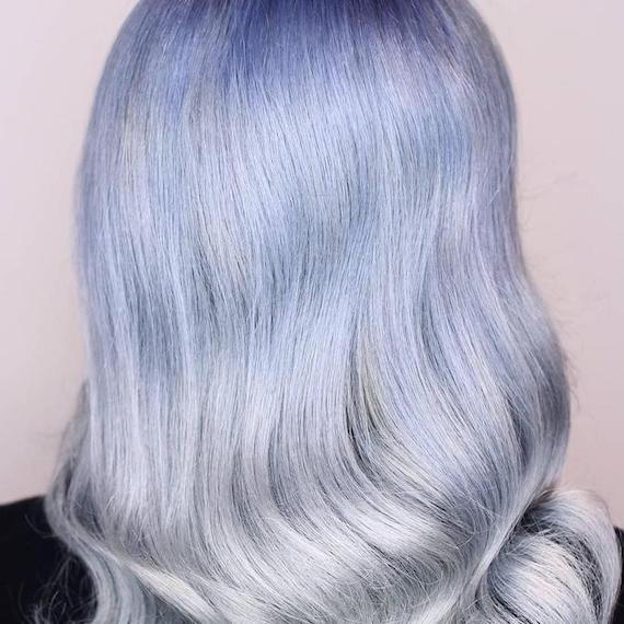 Back of woman’s head with long, glossy, blue gray ombre hair, created using Wella Professionals.
