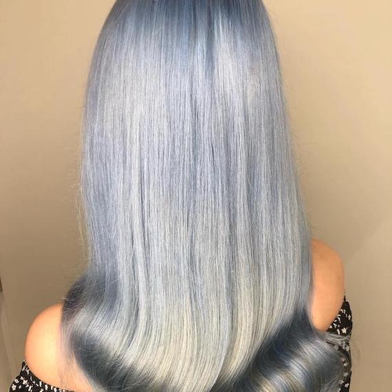 Back of woman’s head with long, shiny, blue steel gray hair, created using Wella Professionals.