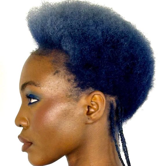 Side profile of model with short, textured hair that segues from stone blue in the top layer to navy blue in the lower layer.