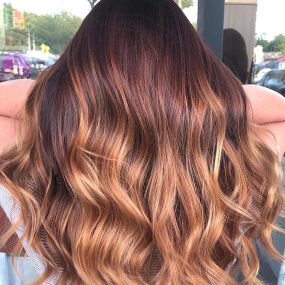 Back of woman’s head with coppery bronde hair, created using Wella Professionals.