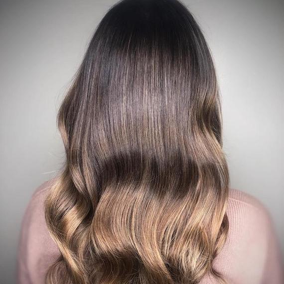 Back of woman’s head with ash brown ombre hair, created using Wella Professionals.