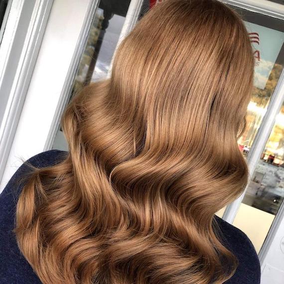 Back of woman’s head with glossy, chestnut brown hair, created using Wella Professionals. 