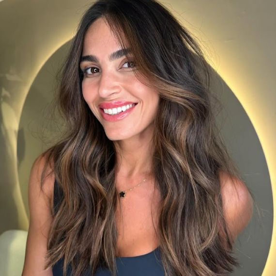 Subtle caramel highlights woven through dark brown hair for a soft, natural glow.