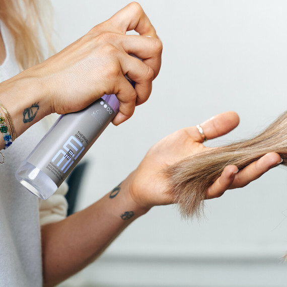 Hairdresser spraying EIMI Thermal Image onto hair