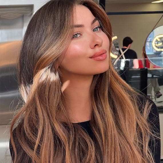 Light chocolate brown hair colour with warm, sun-dappled tones and a bronde effect.