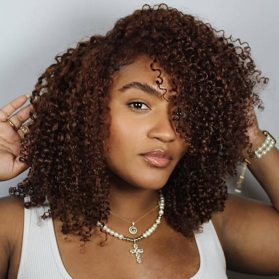 Chocolate cherry hair colour with a blend of red and brown tones for a warm, rich look.