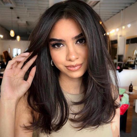 Headshot of a person with dark chocolate hair colour and dark brown eyes