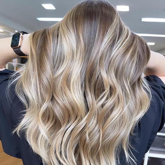 Back of woman’s head with long, beachy blonde hair, created using Wella Professionals.