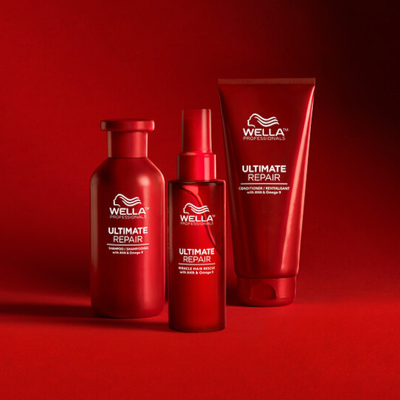 Bottles of Ultimate Repair Shampoo, Conditioner and Miracle Hair Rescue on a red background. 