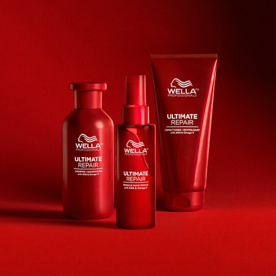 Bottles of Ultimate Repair Shampoo, Conditioner and Miracle Hair Rescue on a red background.