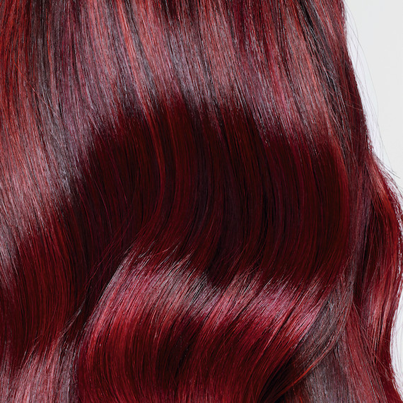 Close-up of cherry red and black hair tones melted together.