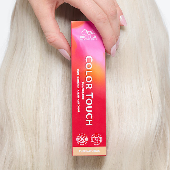 Close-up of platinum blonde hair and a box of Color Touch demi-permanent hair colour.