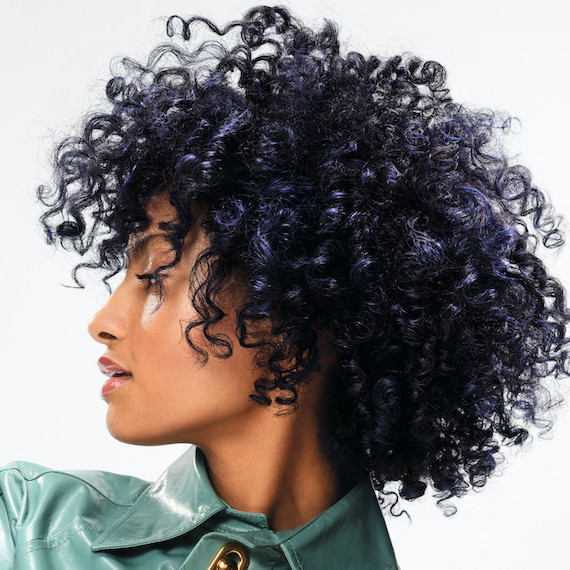 Model with glossy, curly, navy blue and black hair.