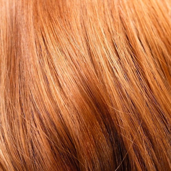 Close-up of apricot blonde glass hair.