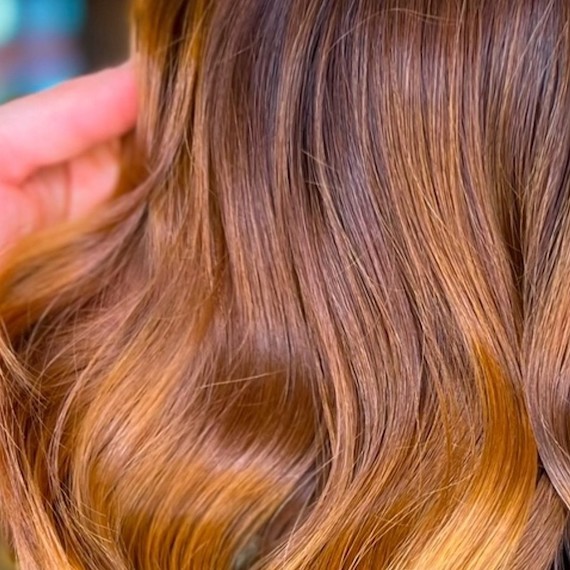 Close-up of copper blonde ombre hair.
