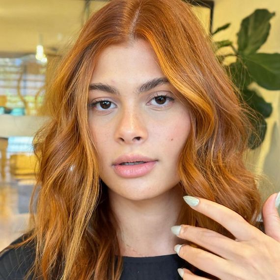 Copper hair with blonde face-framing highlights on front layers.