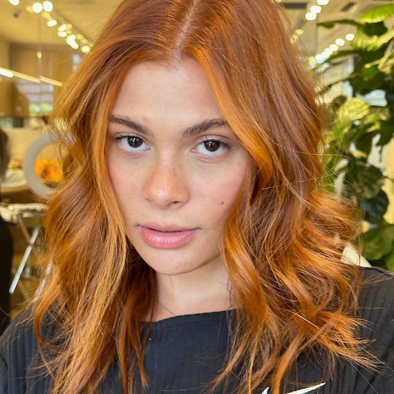 Copper hair with blonde face-framing highlights on front layers.