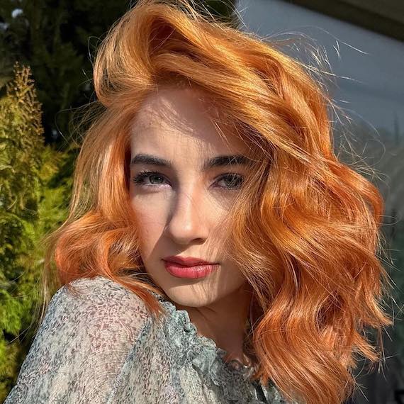 Golden copper blonde hair with a radiant, sunlit finish.