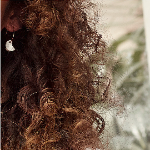 Close-up of chocolate brown, curly hair.