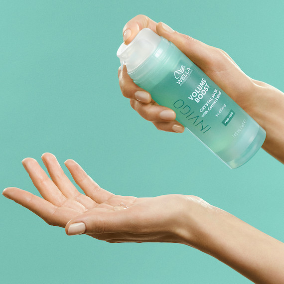 INVIGO Volume Boost Crystal Mask is pumped into a model’s hand.