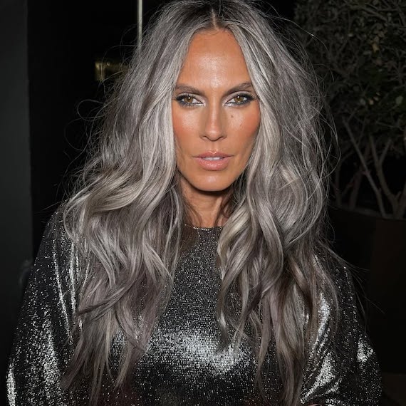 Model with long, tousled, silvery grey hair.