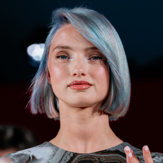 Model with a blonde bob featuring slices of petrol green, blue and purple.
