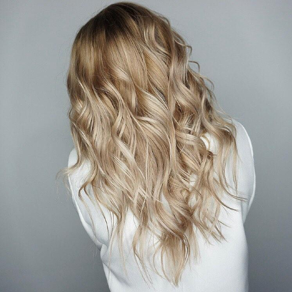 back of woman’s head with blonde illuminage hair