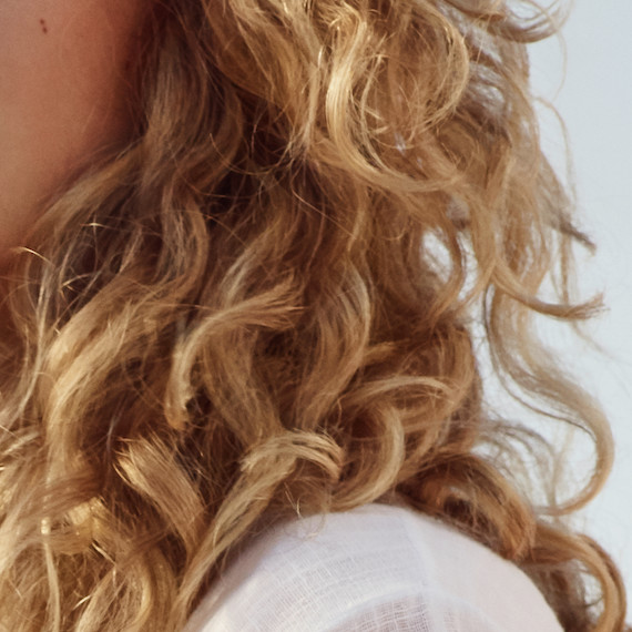 Close-up of blonde, curly hair.