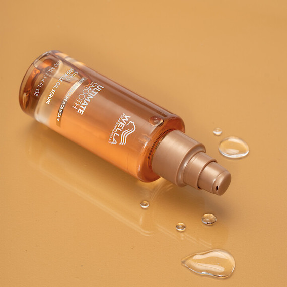 ULTIMATE SMOOTH Miracle Oil Serum bottle on a gold surface.