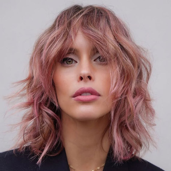 Model with a shag haircut in a dusty pink shade.