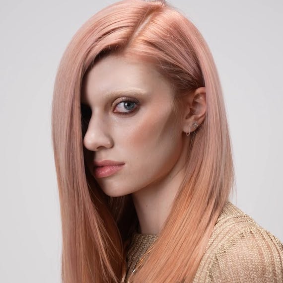 Model with ultra-sleek, rose glass hair.