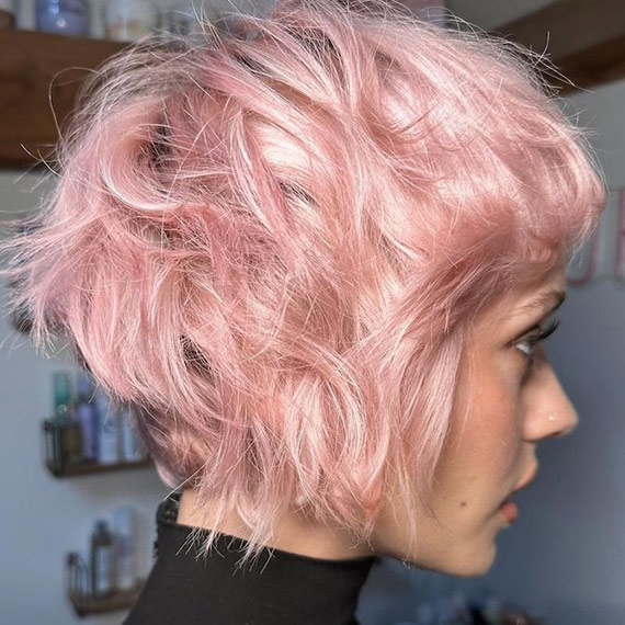 Model with dusty pink pixie haircut.