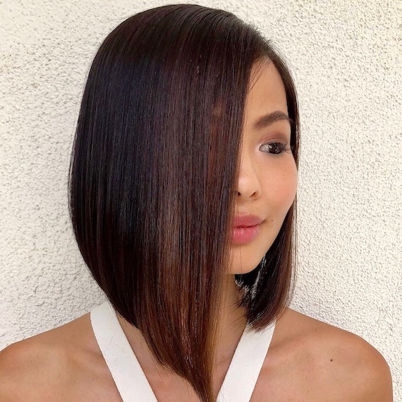 Model with expensive mocha brown hair styled in a sharp bob.