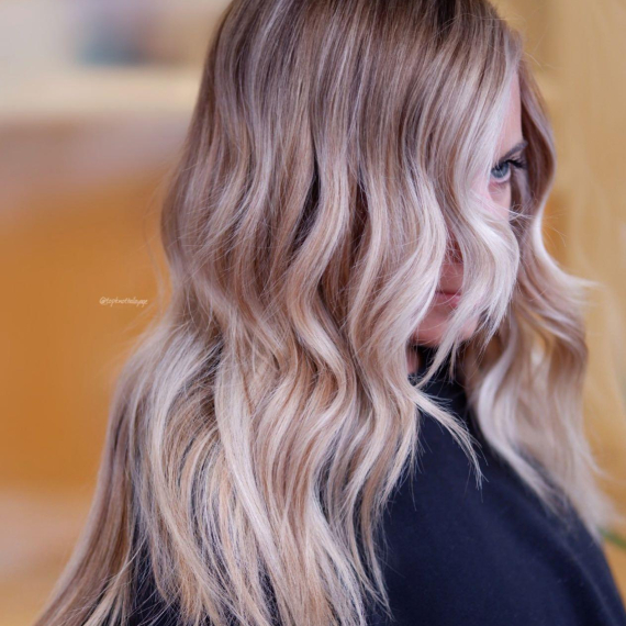 Woman with long,blonde hair and light face-framing highlights