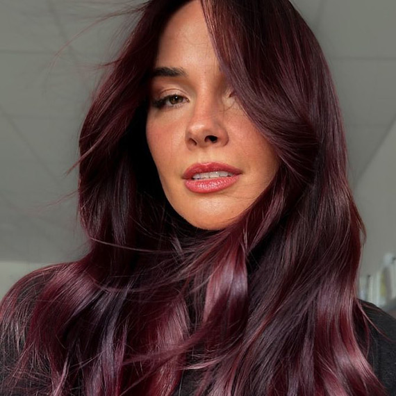 Deep plum hair colour with soft waves.