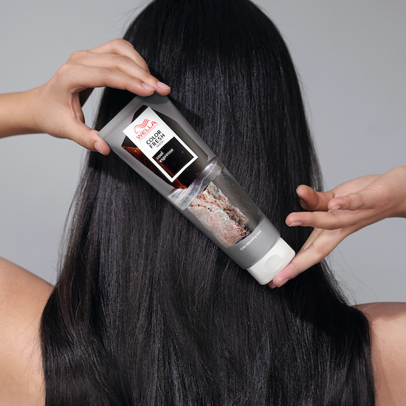 Model with espresso brown hair holds up Color Fresh Mask in Cool Espresso.