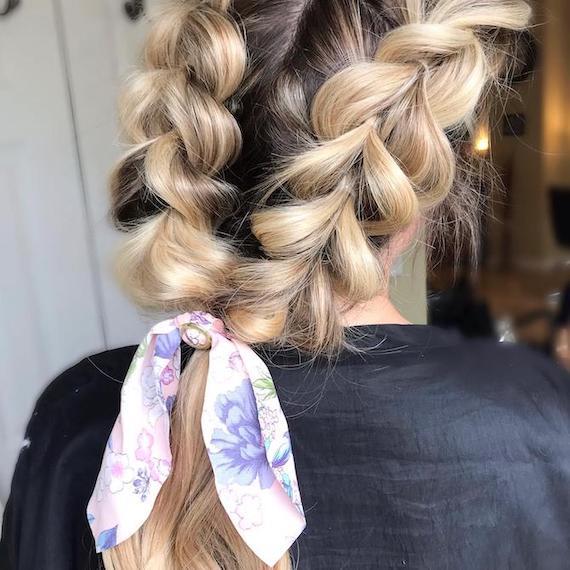 Back of woman’s head with reverse braids tied using a hair scarf.