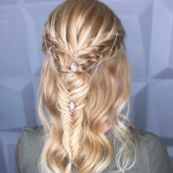 Back of woman’s head with blonde hair, braids and a delicate hair accessory.