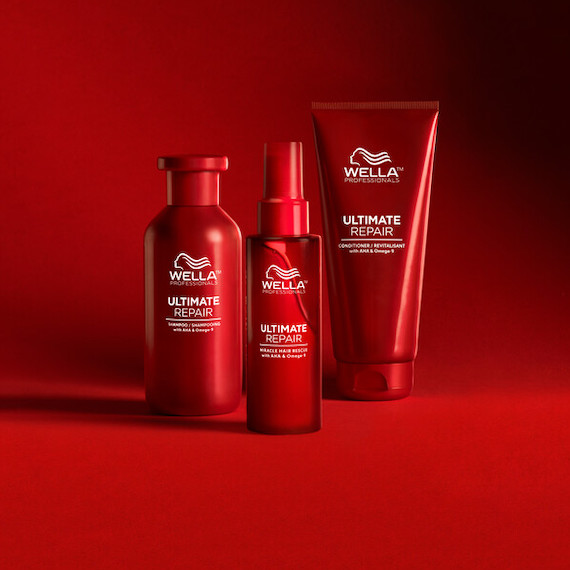 Bottles of Ultimate Repair Shampoo, Ultimate Repair Conditioner and Miracle Hair Rescue on a red backdrop.