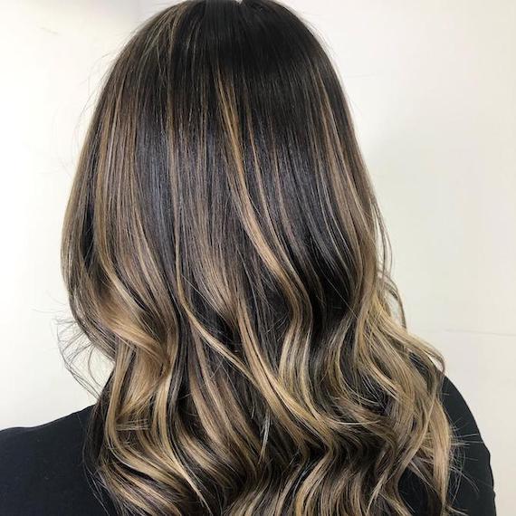 Back of woman’s head with brunette hair and blonde foilyage, created using Wella Professionals.