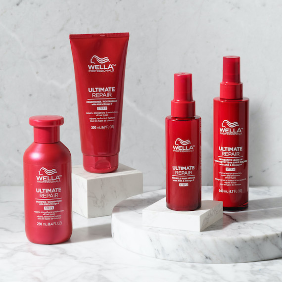 ULTIMATE Repair Shampoo, Conditioner, Miracle Hair Rescue and Protective Leave-In on a marble surface.