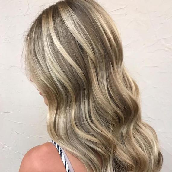 Side profile of woman with champagne blonde frosted hair, created using Wella Professionals.