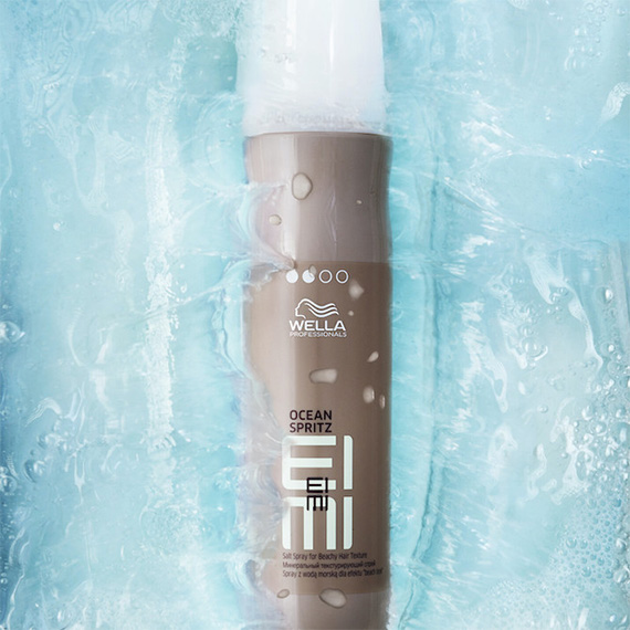 EIMI Ocean Spritz bottle in a pool of water.