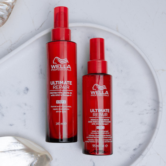 ULTIMATE REPAIR Protective Leave-In and Miracle Hair Rescue on a marble surface.