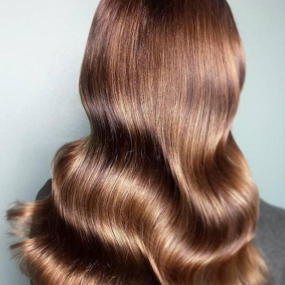 Photo of the back of a woman’s head with long golden brown hair, created using Wella Professionals.