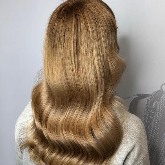 Photo of the back of a woman’s head with light golden brown hair, created using Wella Professionals.