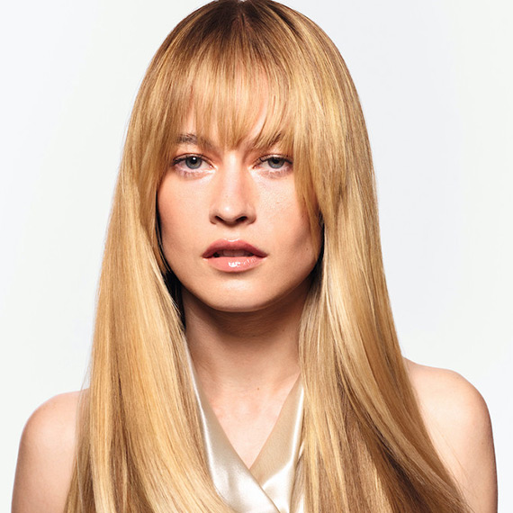 Model with long, straight, ultra-shiny, honey blonde hair.