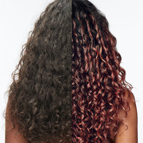 Before and after showing model’s dark brown, curly hair transformed with glassy coral highlights.