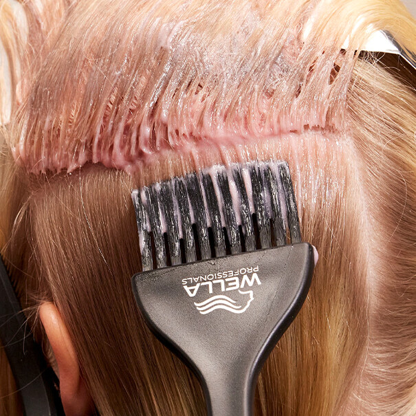 Close-up of SHINEFINITY Color Glaze being applied to the roots of blonde hair.