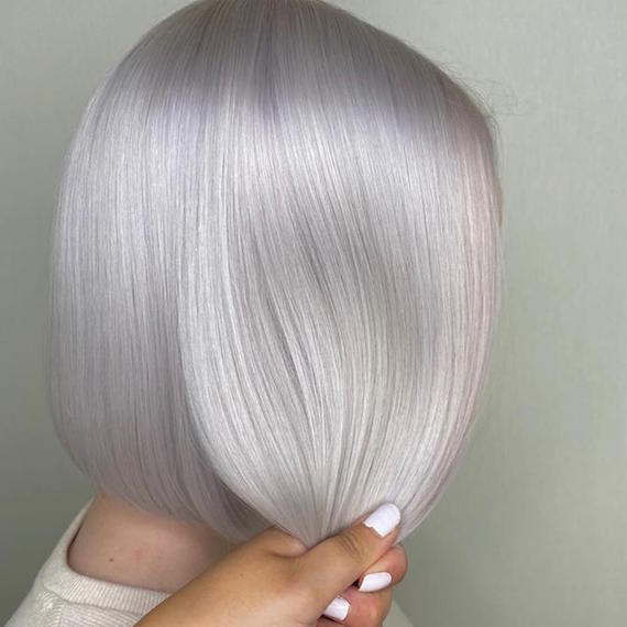 Side profile of woman with gray blonde bob, created using Wella Professionals.